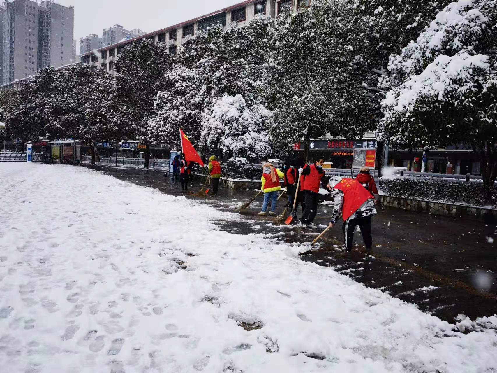 12月27日，安化組織百名青年志愿者開展掃雪除冰志愿活動，志愿者們清掃城區(qū)主干道、人行道的積雪，為車輛以及群眾出行提供安全保障。.jpg